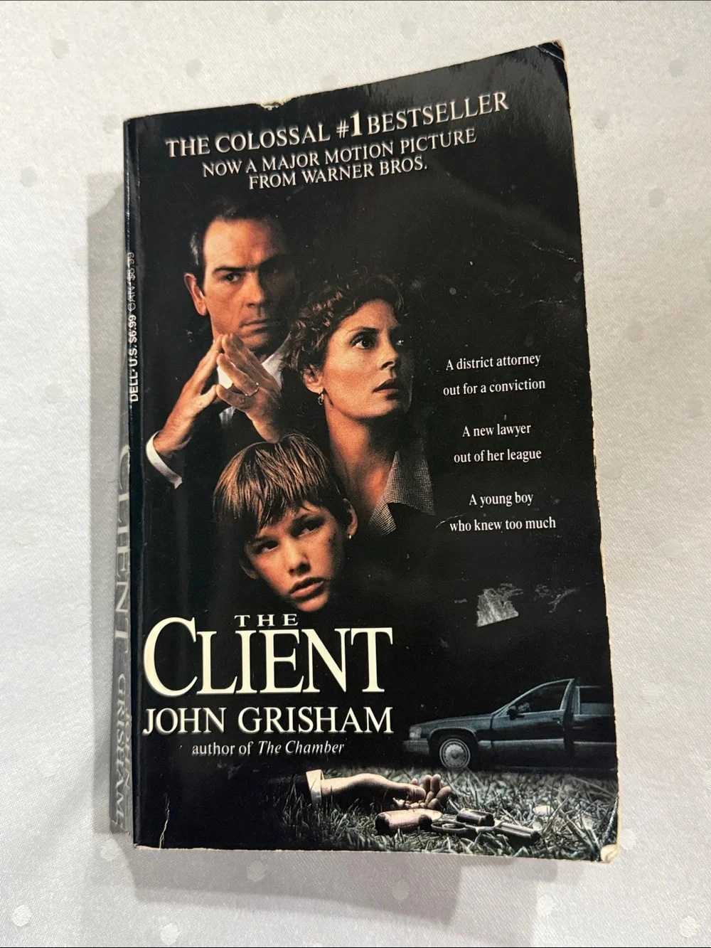 “The Client” a paperback novel by John Grisham